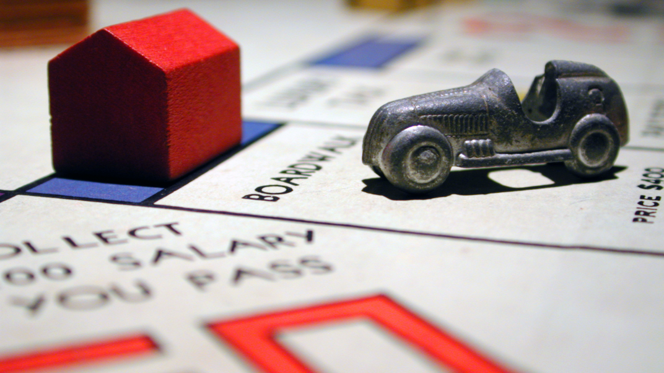 monopoly board game with a token and hotel on the Boardwalk real estate property